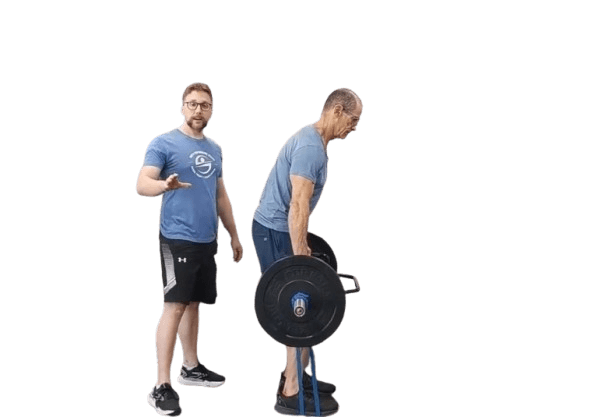 Strength coach teaching a banded isometric deadlift at Smith Performance Center, emphasizing proper technique, core activation, and injury prevention.