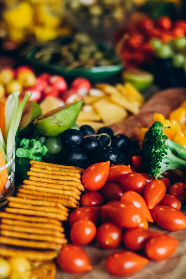 Vibrant display of fresh fruits, vegetables, crackers, and meats perfect for a party platter. Photo by Irna Novikova. License by Pexels.com