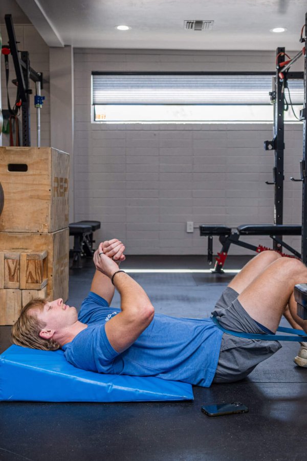 Braden Johnson Demonstrating Banded Lumbar Traction for Low Back Pain Braden Johnson demonstrating banded lumbar traction at Smith Performance Center in Tucson, aiding clients with low back pain in regaining movement confidence and tissue capacity.